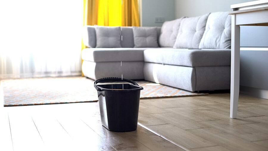 bucket catching water from a roof leak